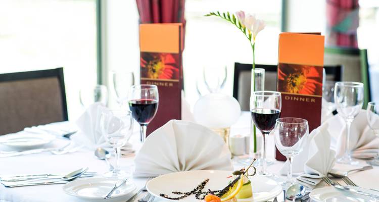 Elegant dining table set with wine glasses and a stylish centerpiece.