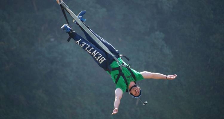 Person bungee jumping with arms outstretched.