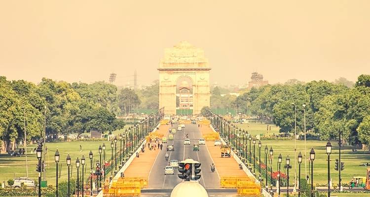 Iconic India Gate structure amidst a hazy atmosphere.