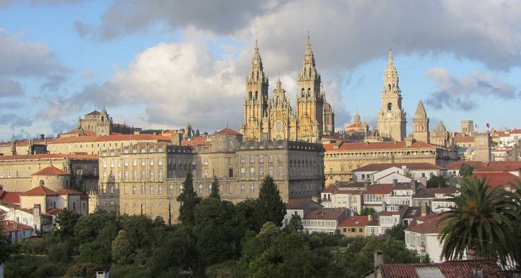 A distant view of the Santiago de Compostela Cathedral with surrounding cityscape.