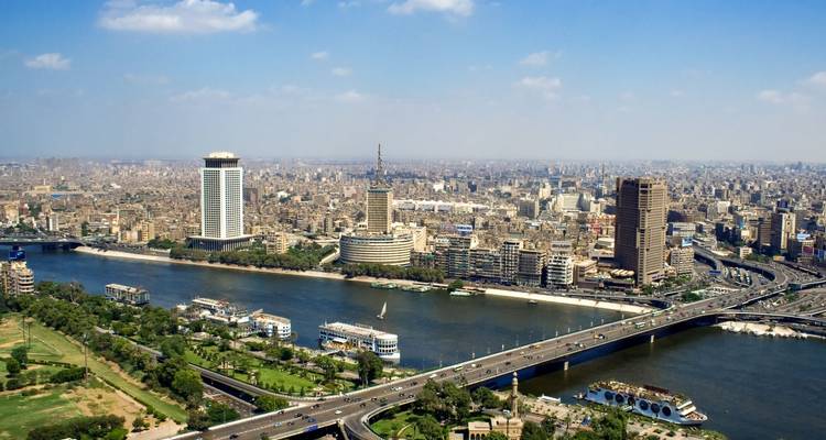 Aerial view of urban landscape with a river and modern buildings.