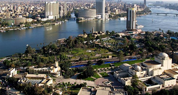 Aerial view of cityscape with parks and river.