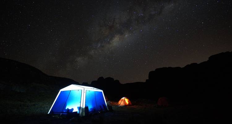 Tents set up under a starry sky.