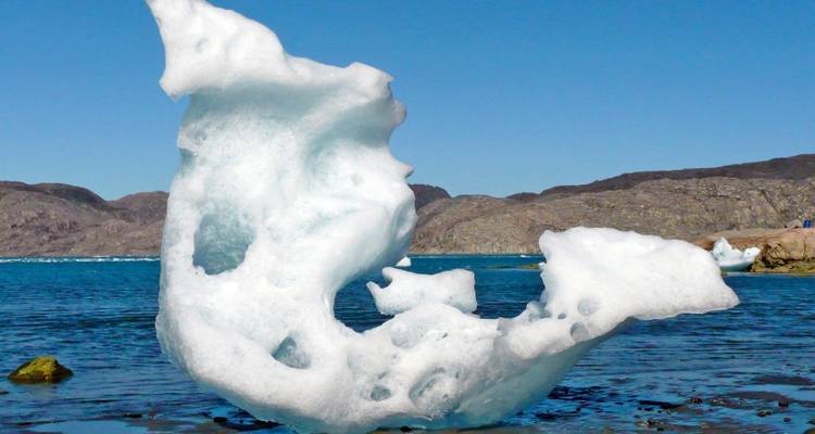 Floating iceberg with intricate shapes.