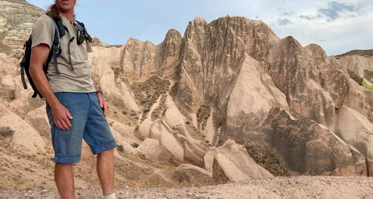Person hiking among rock formations.