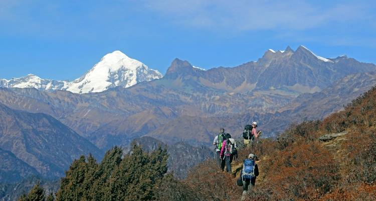 A group of hikers trekking through mountainous terrain.