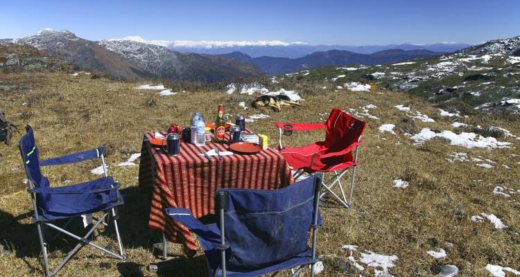 Picnic setup with chairs in a mountain landscape