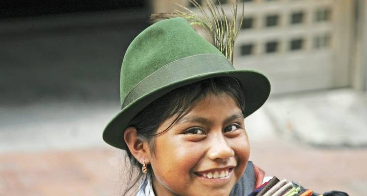 Person wearing a green hat and smiling.