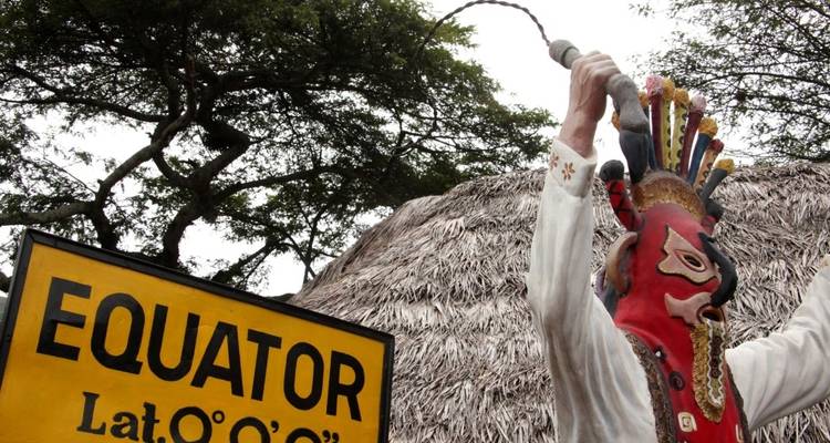 Equator sign with a bright statue of a figure.