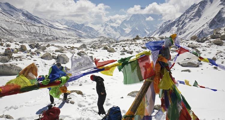 Tibetan prayer flags in a snowy mountain landscape