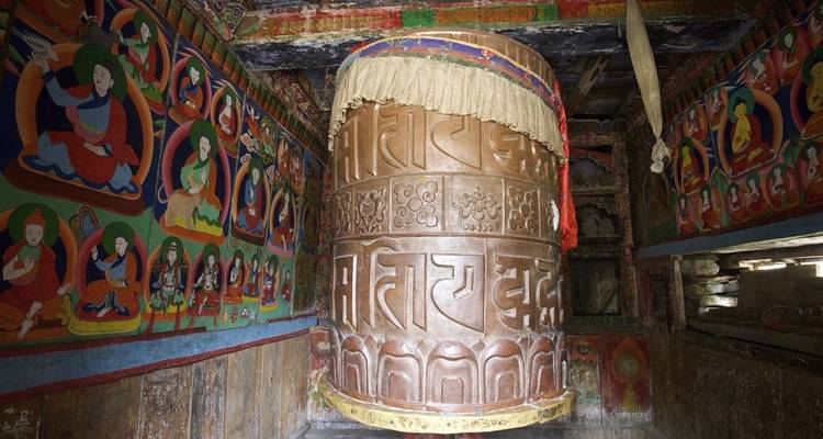 Large prayer wheel in a colorful room