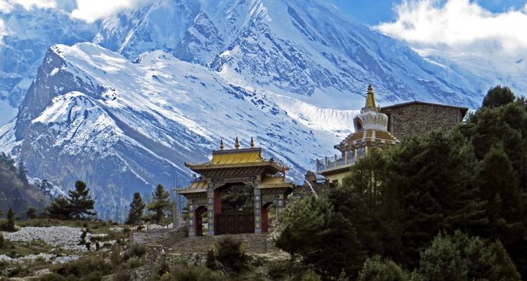 Buddhist monastery with snowy mountain backdrop