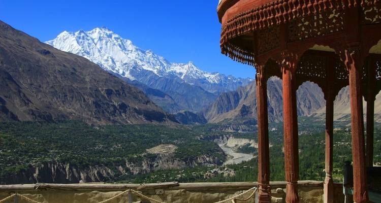 Stunning mountain landscape with a traditional structure overlooking the valley.