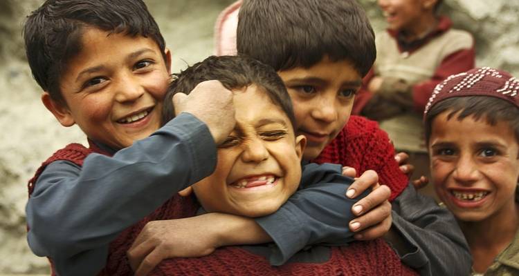 Group of children playing and laughing together.