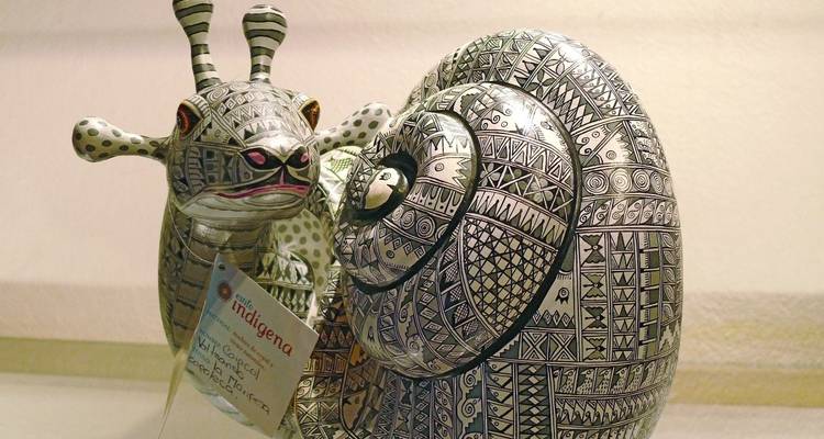 A decorative ceramic snail sculpture with intricate patterns.