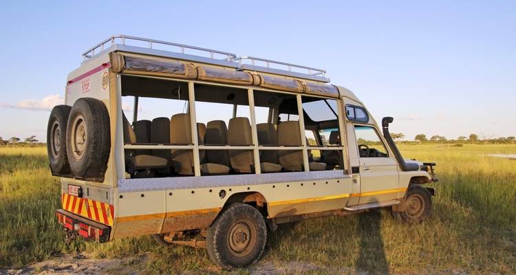 Safari vehicle in an open field