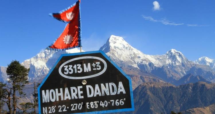 View of Mohare Danda sign with mountains in the background.