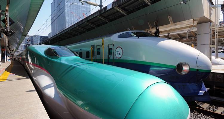Dos trenes bala Shinkansen en una plataforma de estación.