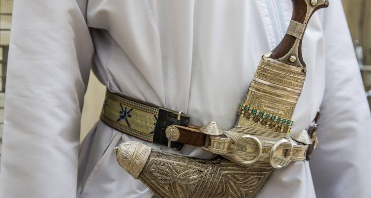 Omani khanjar (dagger) worn with a traditional belt.