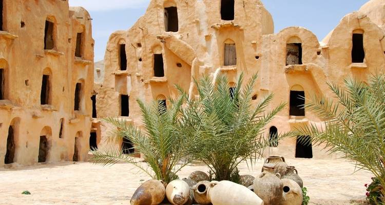 Historic desert architecture with clay buildings and pottery.