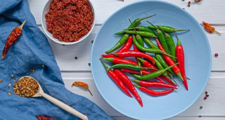 Plate with fresh green and red chili peppers.