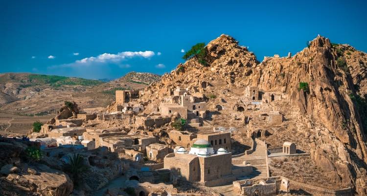 Scenic view of a historic village on a rocky hill.