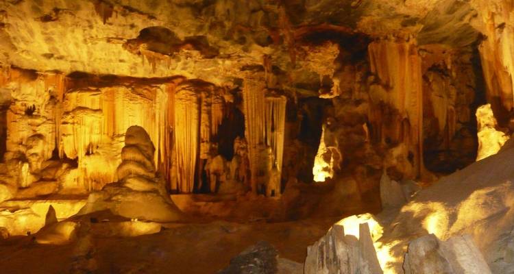 Illuminated stalactites and stalagmites in a cave.