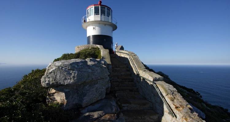 Lighthouse on a cliff with ocean view.