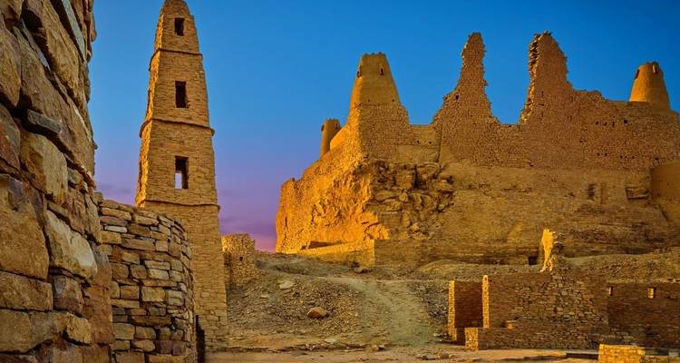 Ancient ruins illuminated in golden light.