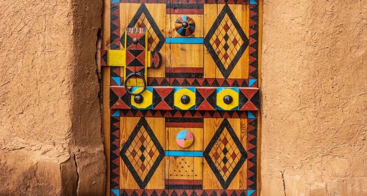 Decorative wooden door with colorful geometric patterns.