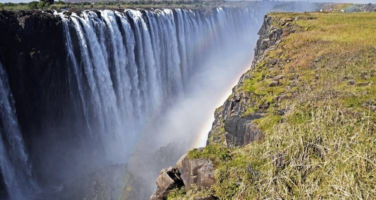 Victoria Falls with a rainbow over the edge.