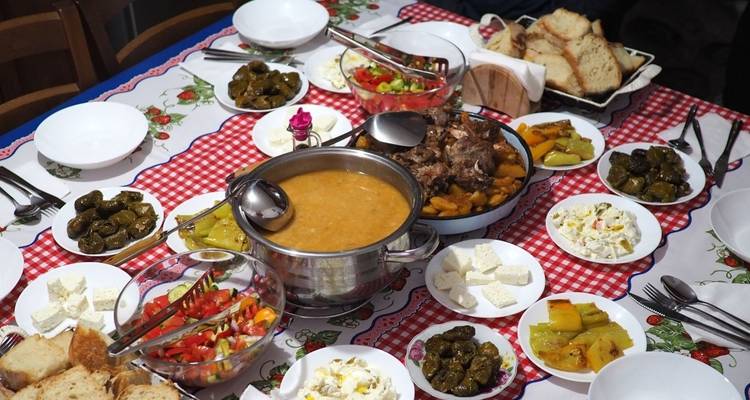 A traditional spread of food on a red checkered tablecloth.