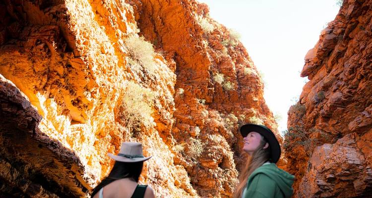 Two women exploring a red rock canyon.