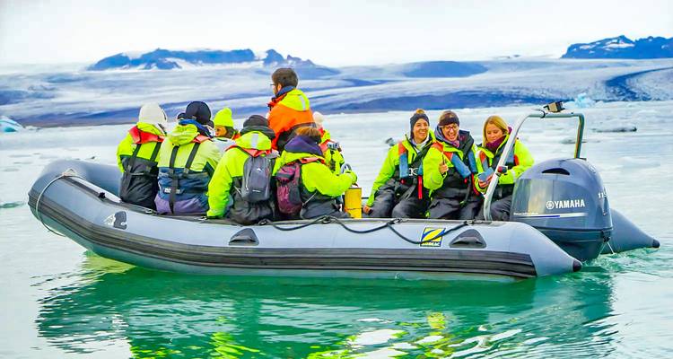 Tourists on a boat in a glacial lagoon