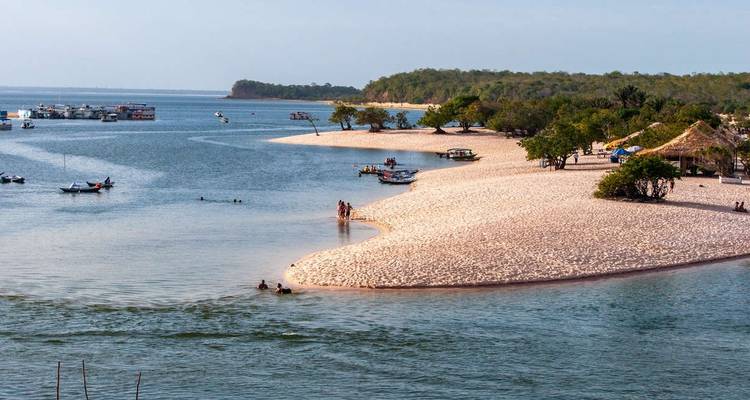 A scenic beach with people enjoying the shoreline.