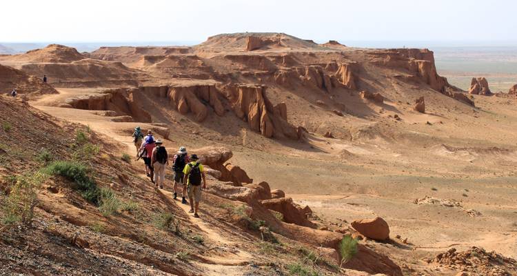 A group of people hiking along a rocky ridge.