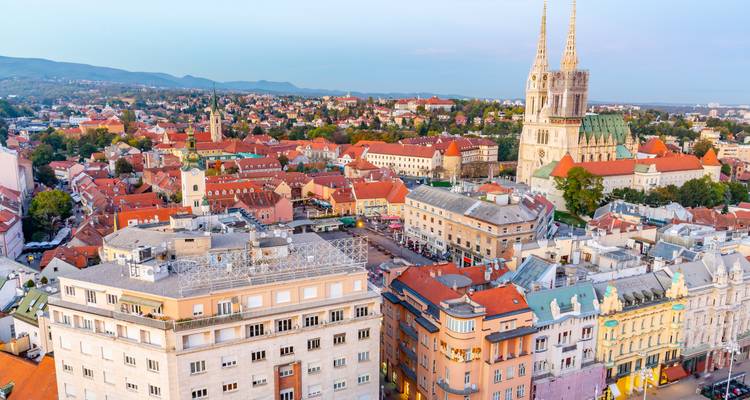 An urban view from above featuring historic architecture and a cathedral.