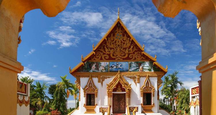 Verzierte Tempelfassade mit kunstvollen Designs und blauem Himmel.
