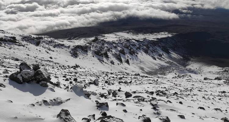 Panoramic view from a snowy mountain summit.