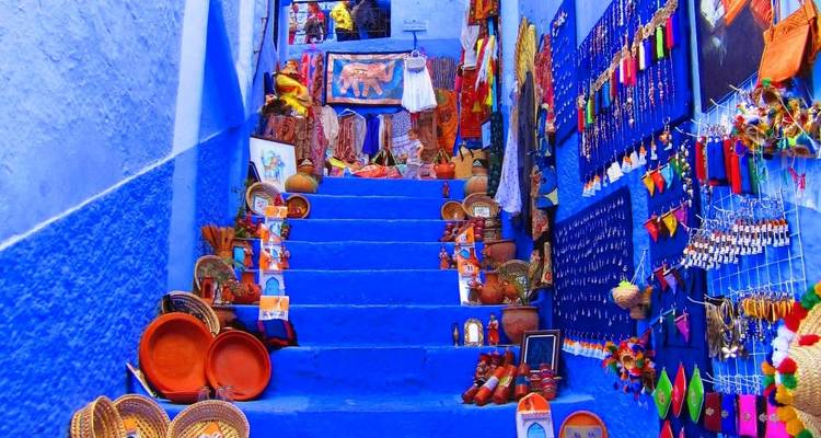 Vibrant blue stairs with shops and traditional goods.