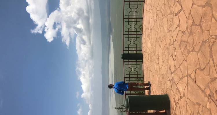 Person looking out over a scenic viewpoint.