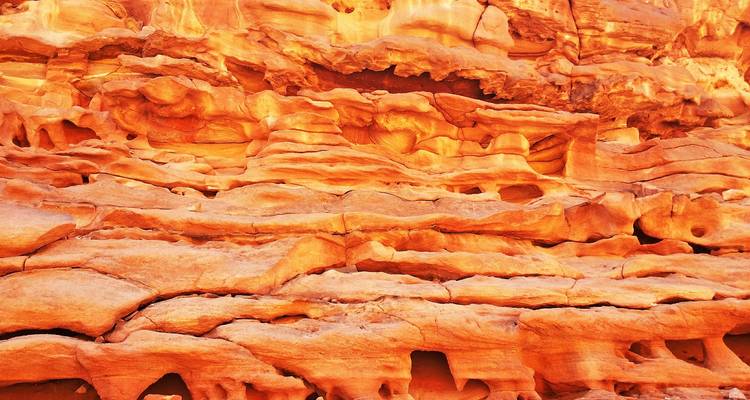 Textured and colorful rock formations.