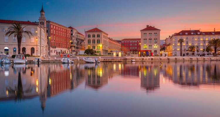 Beautiful waterfront view of historic buildings at sunset.