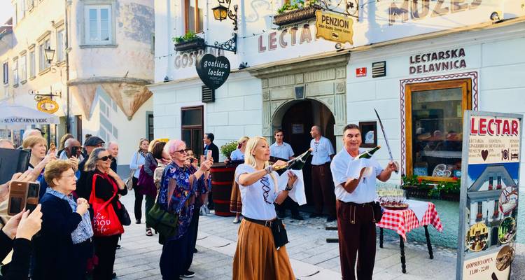 Street performers with sabers in front of a crowd.
