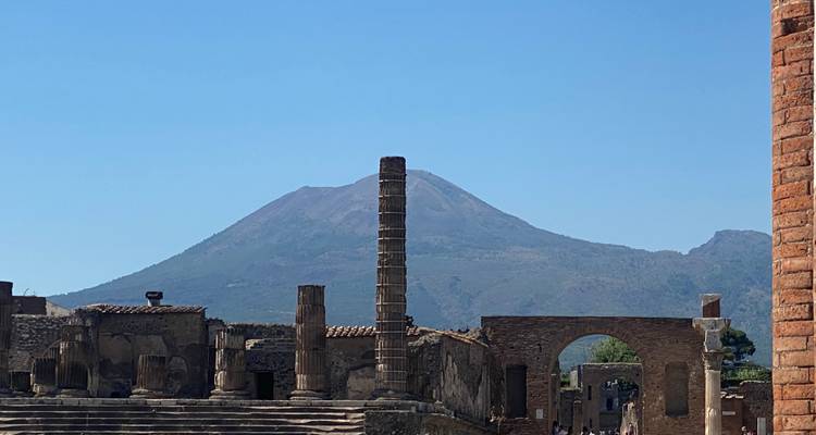 Ruins with a mountain in the background.