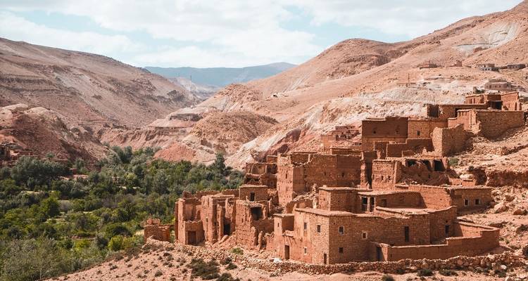 Traditional Moroccan buildings on rocky hills.