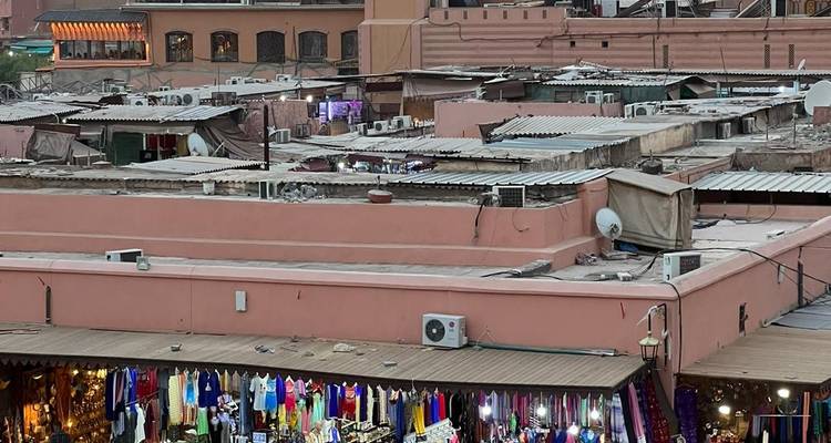 Rooftop market with colorful merchandise and rooftops.