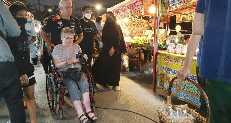 People at a night market with stalls.