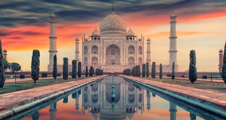 The iconic Taj Mahal reflecting beautifully in water during sunset.