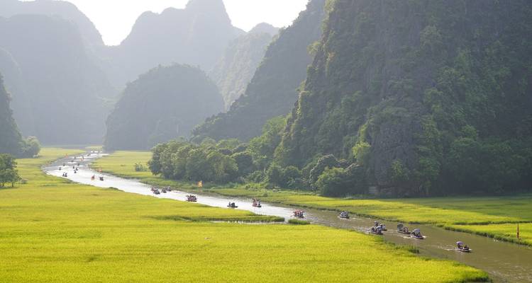 River with boats and limestone mountains.